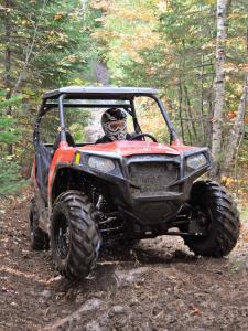 2012.polaris.rzr570.red_.front_.riding.on-trails.jpg