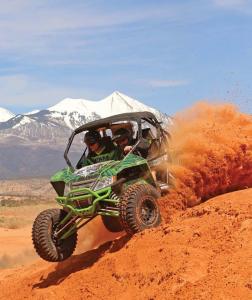 2017.arctic-cat.wildcat-sport.black-and-green.front-left.riding.on-sand.jpg