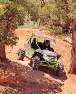 2017.arctic-cat.wildcat-sport.black-and-green.front-right.riding.down-rocks.jpg